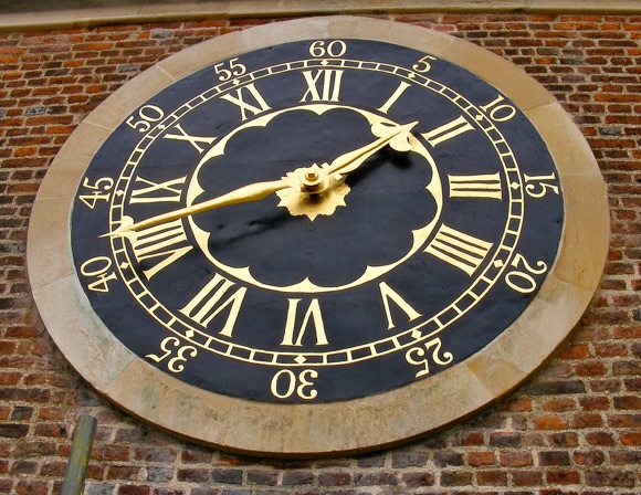 Re-gilded clock face of Luptons Tower, Eton College.  Carried out by Gary Churchman, Stone Carver